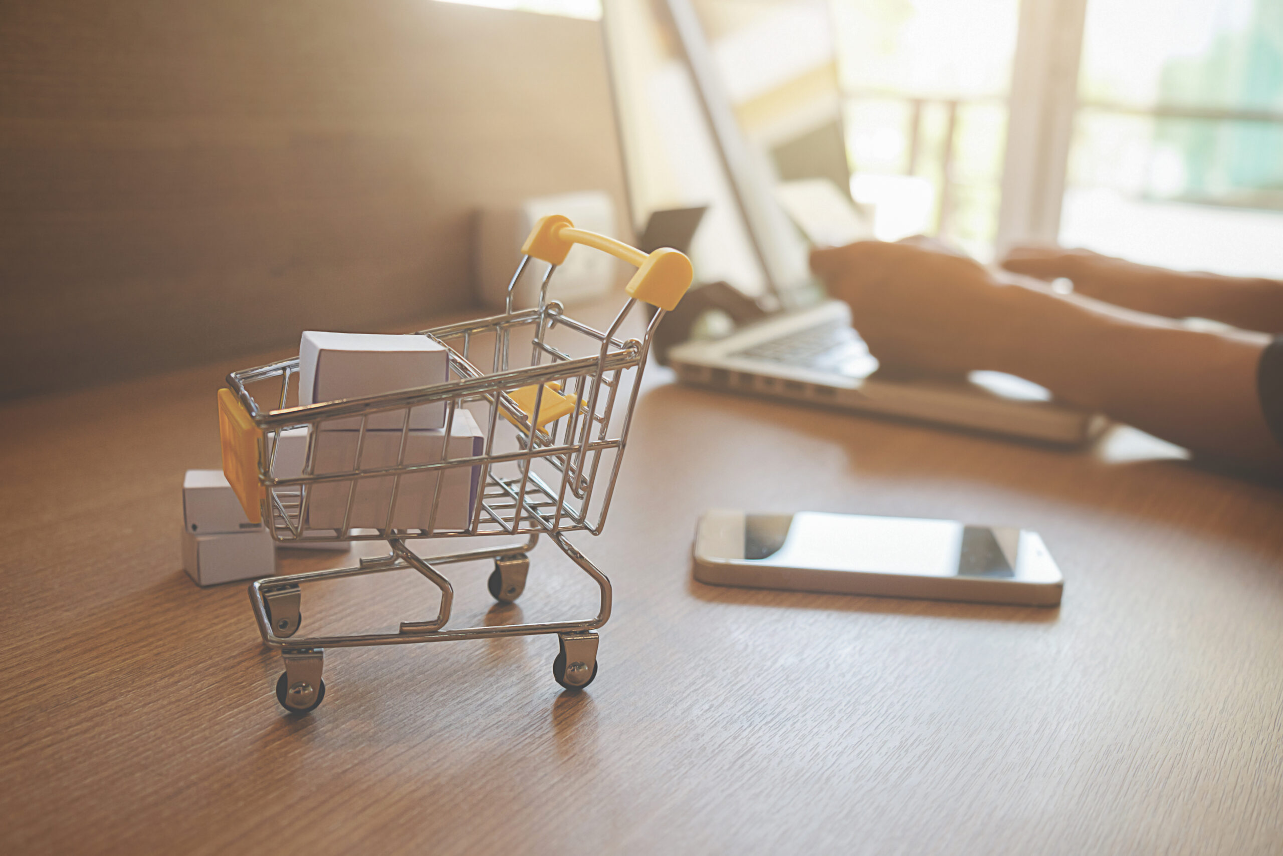 Internet online shopping concept with laptop and shopping-cart.Vintage tone retro filter effect,soft focus(selective focus)